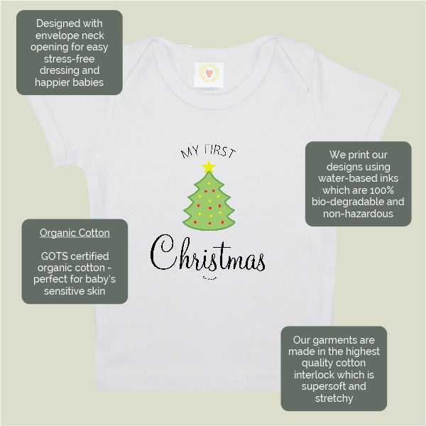 White long-sleeve baby t-shirt with a green Christmas tree graphic and the words 'MY FIRST Christmas' on the front, shown on a light beige background with four dark gray feature callout boxes.