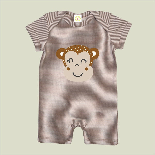 Striped baby romper with monkey face design on a beige background