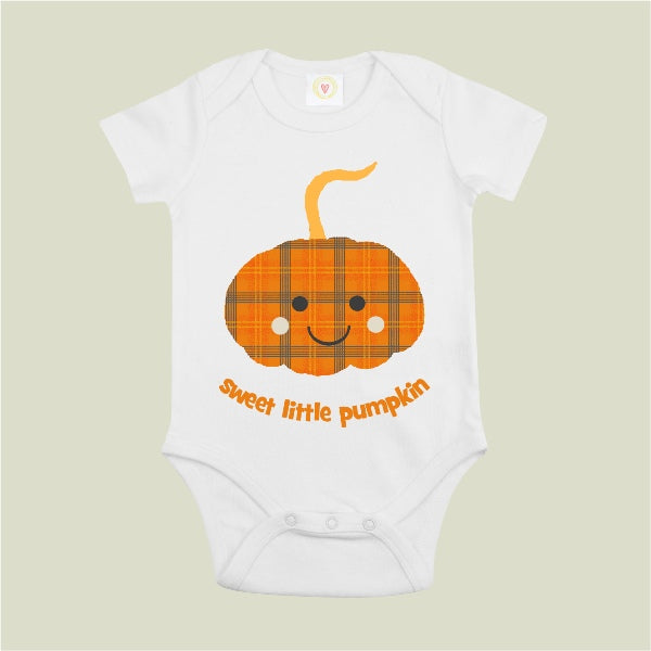 White baby onesie with a plaid pumpkin design and 'sweet little pumpkin' text on a beige background