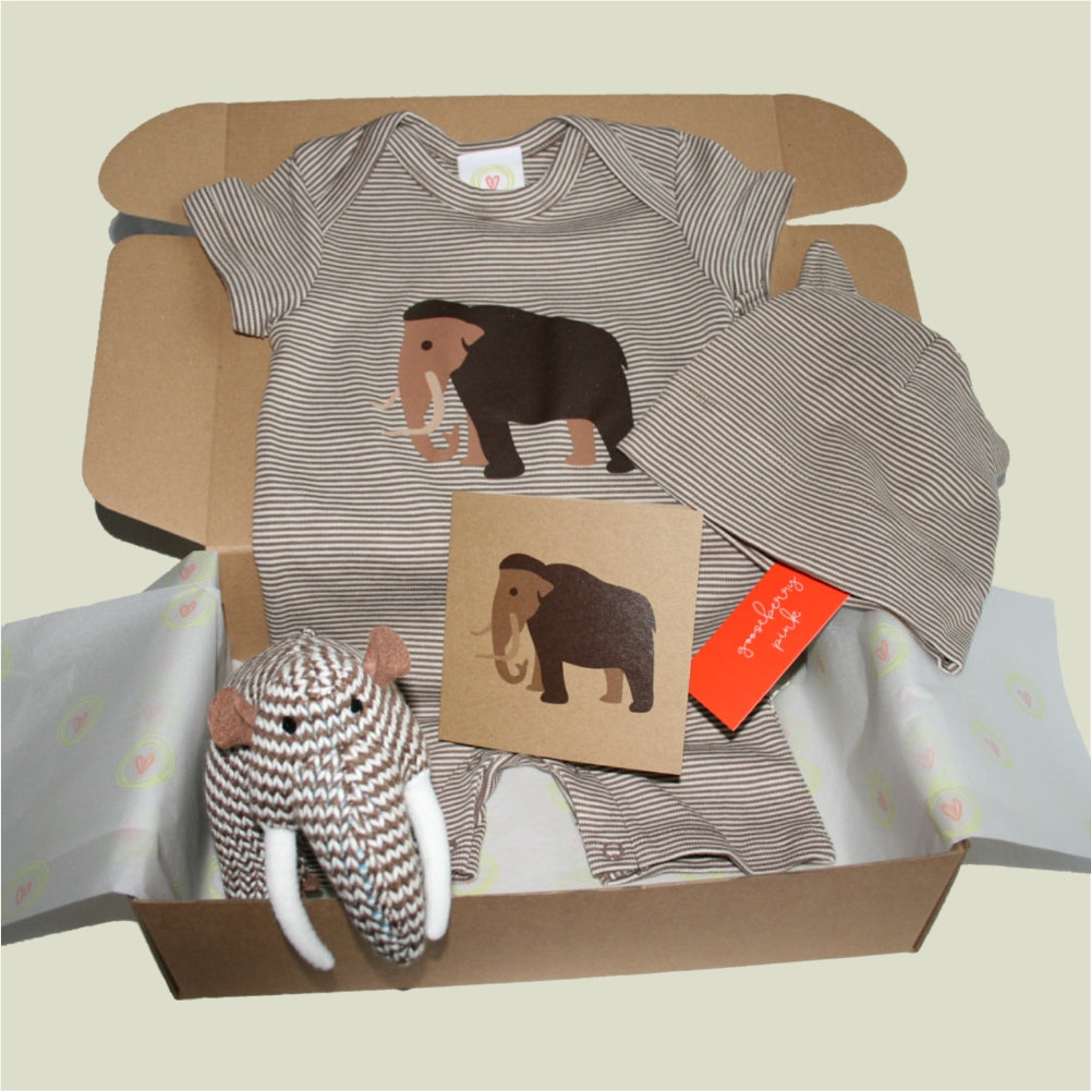Woolly mammoth baby gift box with striped playsuit, hat, plush rattle, and kraft card