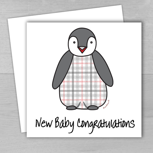 A new baby greeting card with a cute tartan penguin design, accompanied by a matching recycled envelope. The card is displayed with a 'New Baby Congratulations' message.