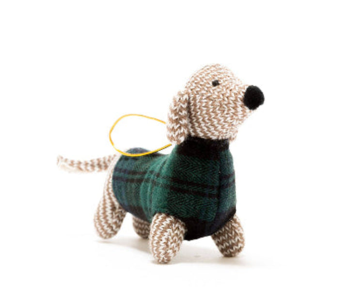 Knitted dog toy wearing a plaid sweater on a white background