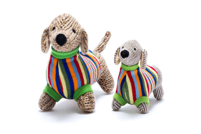 Two knitted dog toys with colorful striped sweaters on a white background