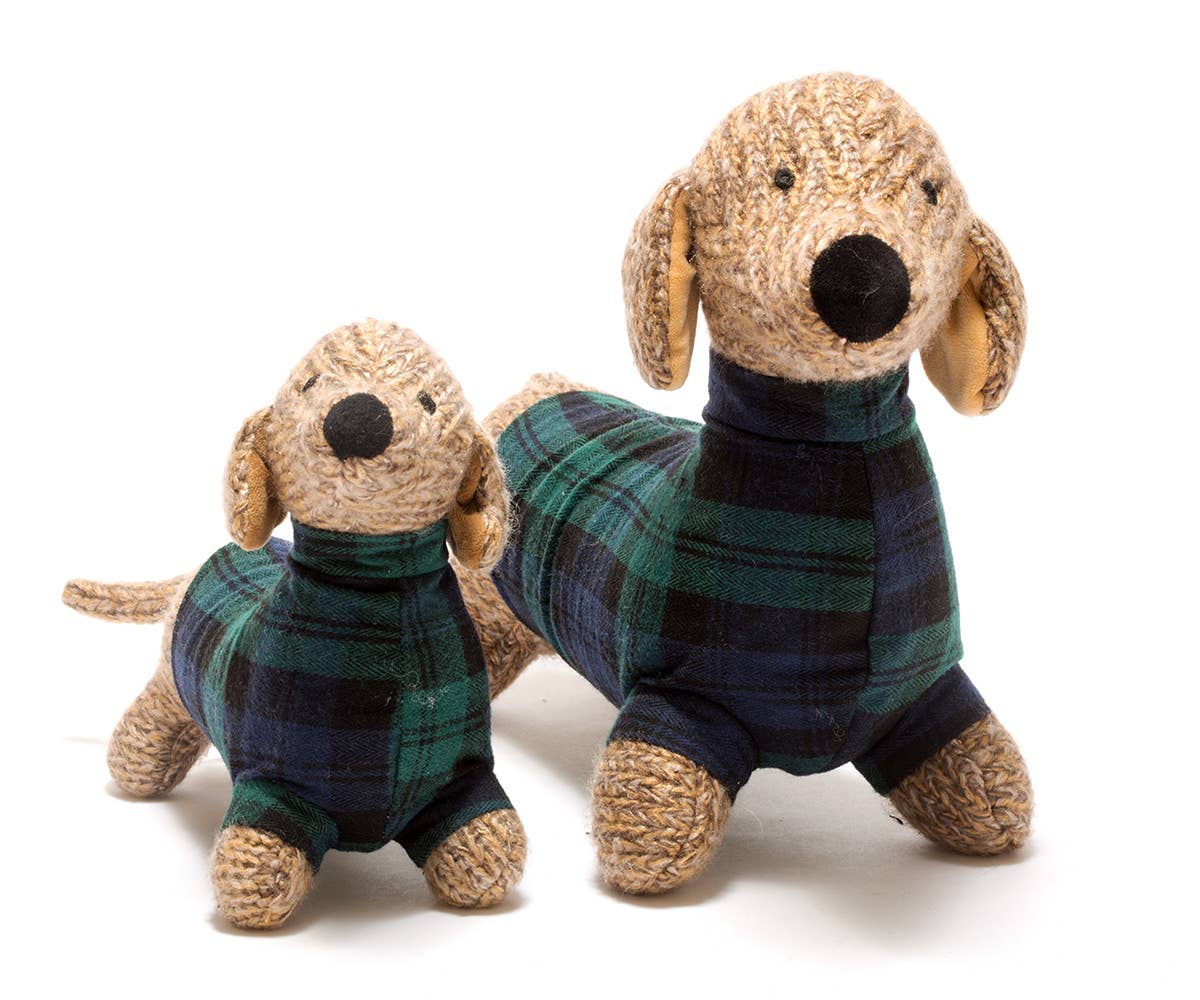 Two dog-shaped toys wearing plaid outfits on a white background