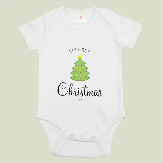 A white short-sleeve baby bodysuit with a graphic print of a green Christmas tree and the text 'MY FIRST Christmas' on a light beige background.