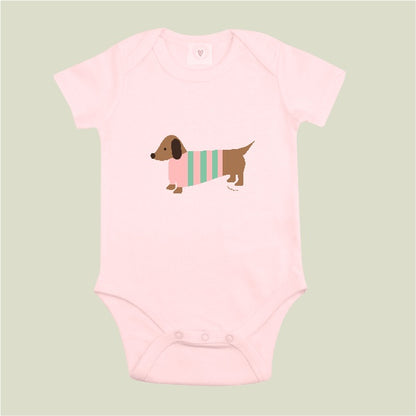 Organic cotton pink baby bodysuit with hand-printed sausage dog design