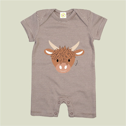 Striped baby romper with a highland cow design on a beige background