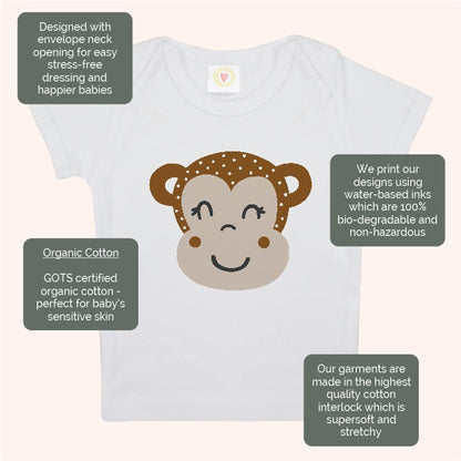 Baby t-shirt with monkey design and certification labels on a white background