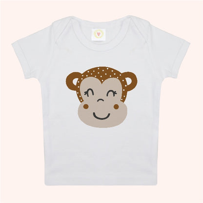 White t-shirt with a monkey face design on a light pink background