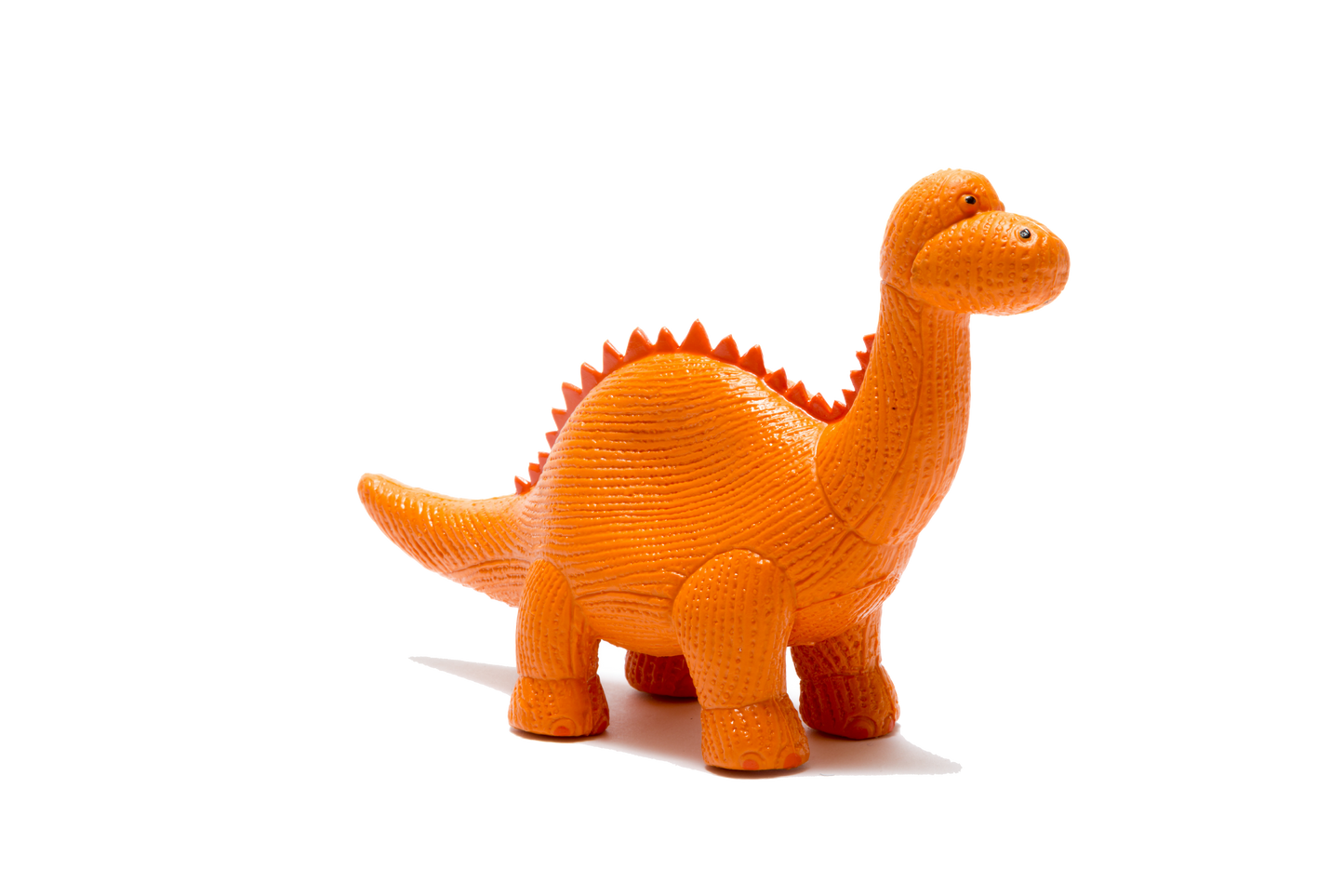 An orange textured toy dinosaur with a long neck and spiky back, standing on a plain white background.