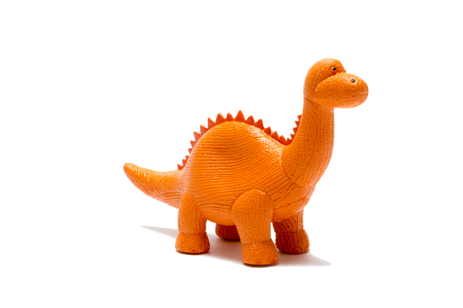An orange textured toy dinosaur with a long neck and spiky back, standing on a plain white background.