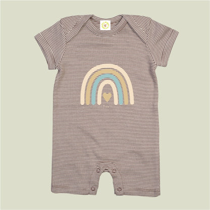 Striped baby romper with rainbow design on a beige background