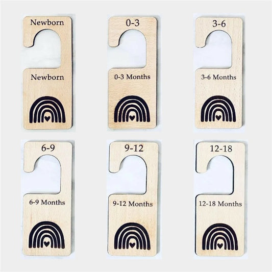 Set of wooden age dividers with rainbow and heart designs on a light gray background
