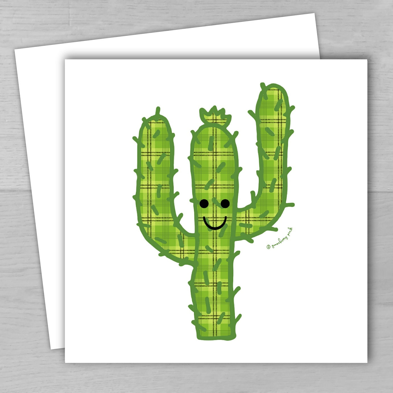 Card with a smiling plaid cactus design on a white background