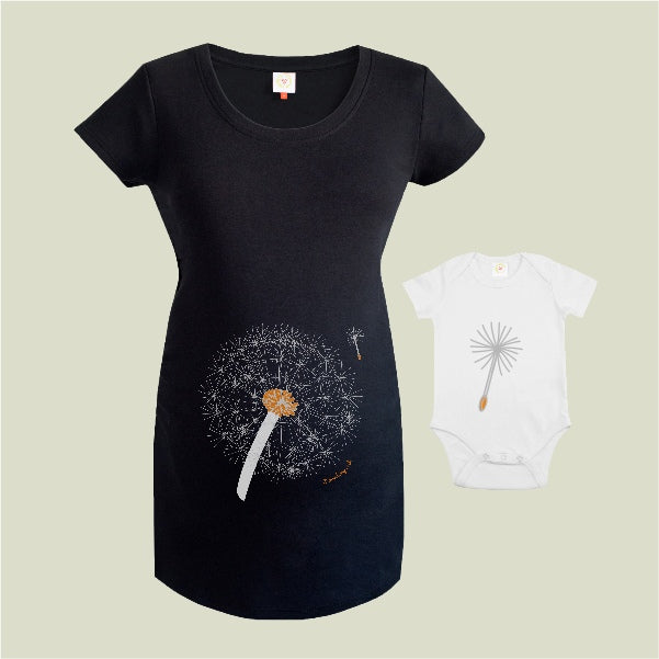 Black t-shirt and white baby onesie with dandelion design on a beige background