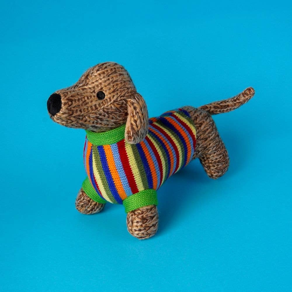 Knitted dog toy with a colorful striped sweater on a blue background