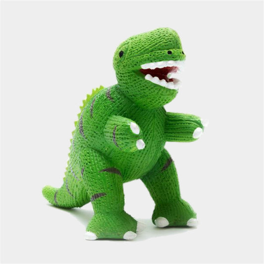 A green knitted dinosaur toy with purple stripes, white claws, and an open mouth showing white teeth, photographed against a light gray background.