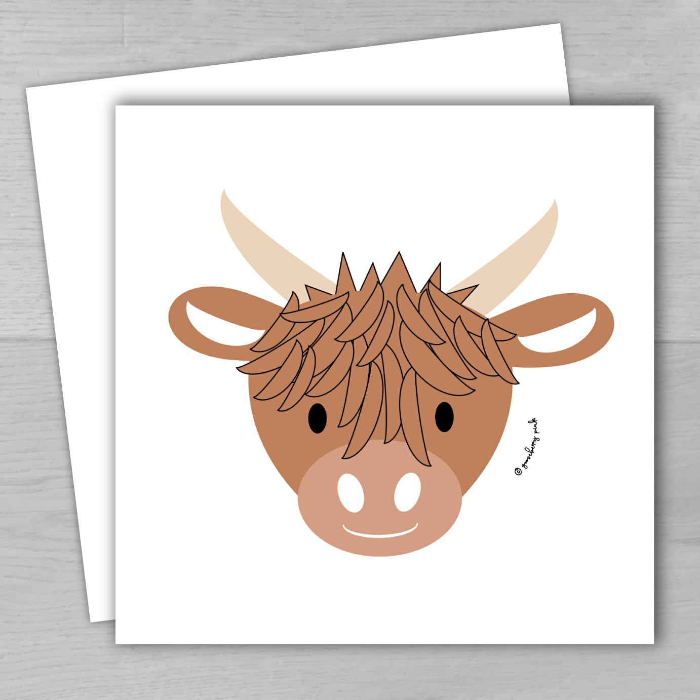 Illustration of a brown cow's head on a white card with a gray background