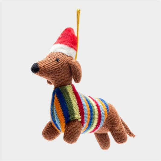 Knitted dog ornament with a colorful sweater and Santa hat on a white background